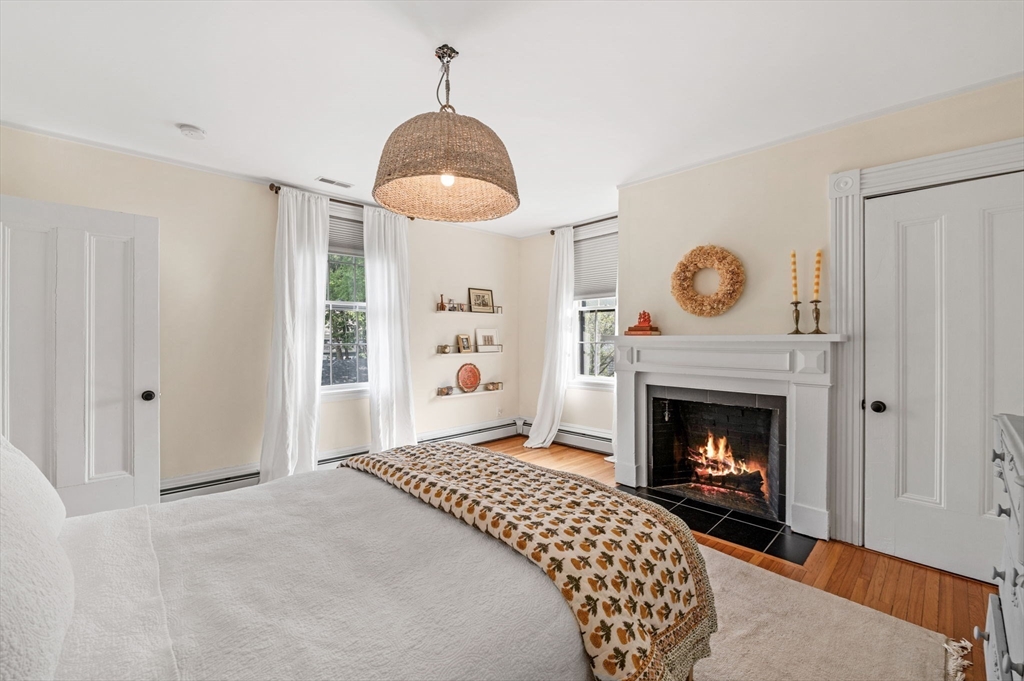 31 Broad Street Salem, MA 01970 - Photo 29 of 39 a bedroom with a bed and a fireplace