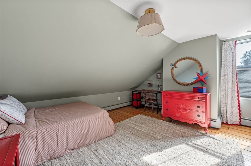 31 Broad Street Salem, MA 01970 - Photo 34 of 39 a bedroom with a bed and a chandelier