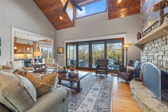 a view of a dining room with furniture a chandelier and wooden floor