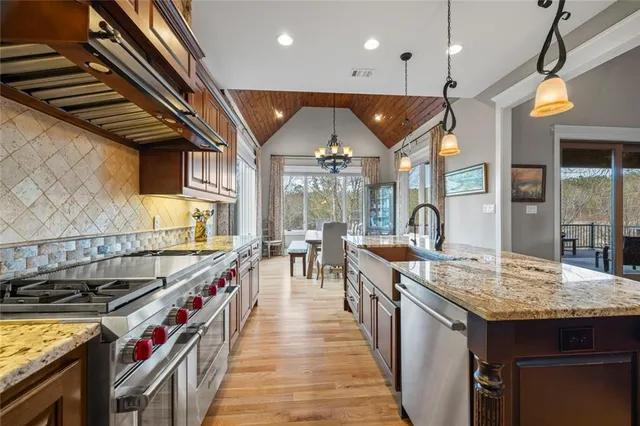 a kitchen with stainless steel appliances granite countertop a sink and stove top oven