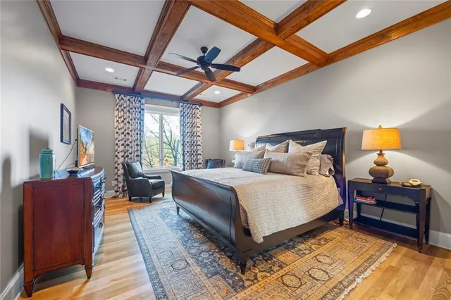 a bedroom with a bed and a flat tv screen on dresser