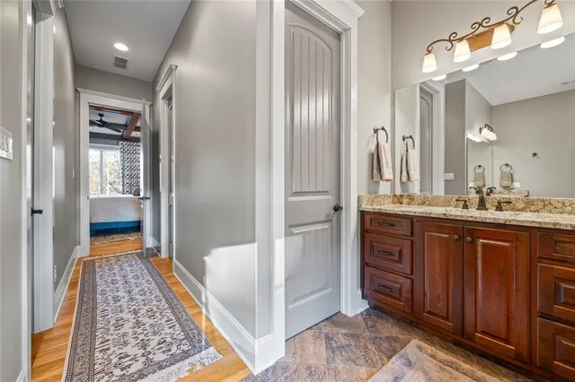 a bedroom with a large bed and a ceiling fan