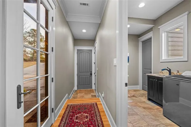 a front view of a house with a yard and large tree