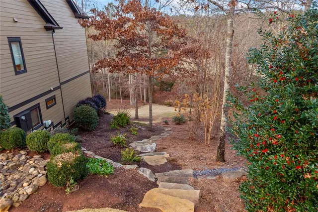 a living room with furniture a fireplace and a large window