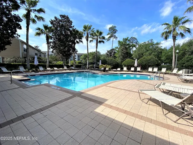 a view of a swimming pool and lounge chairs