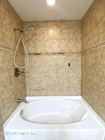 a bathroom with a bath tub and shower