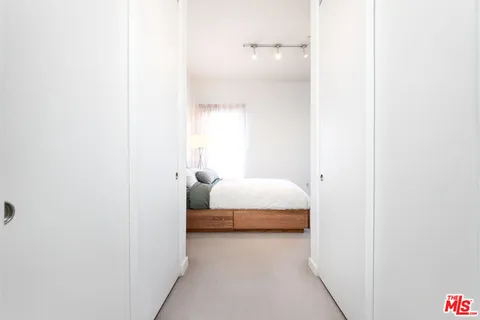 a bedroom with a bed and a night stand