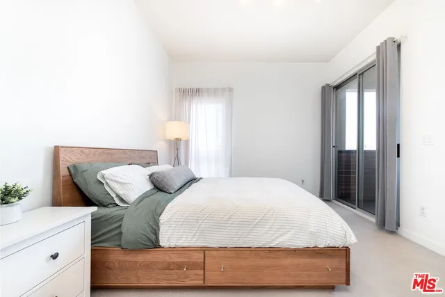 a bedroom with a bed and window