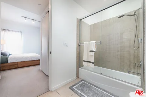 a bathroom with a bathtub and a shower