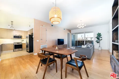 a dining room with furniture and wooden floor