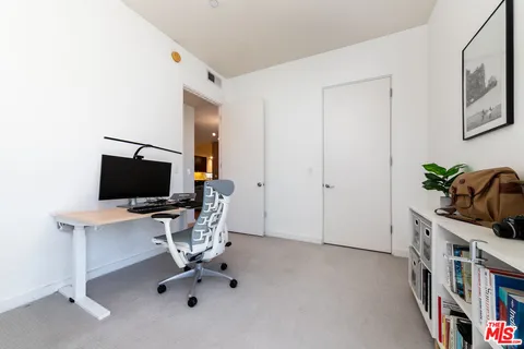 a workspace with furniture and mirror