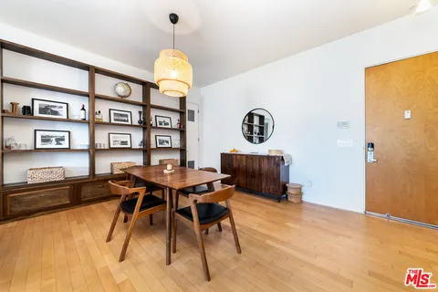 a view of a workspace with furniture and a potted plant