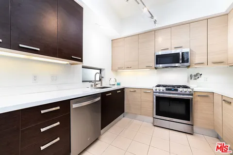 a kitchen with stainless steel appliances granite countertop a sink and a stove