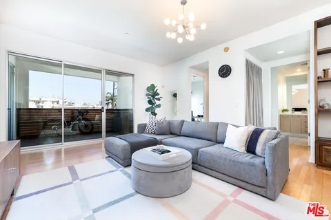 a living room with furniture a rug and a chandelier