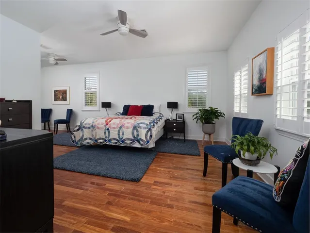 a living room with stainless steel appliances kitchen island granite countertop furniture and a wooden floor