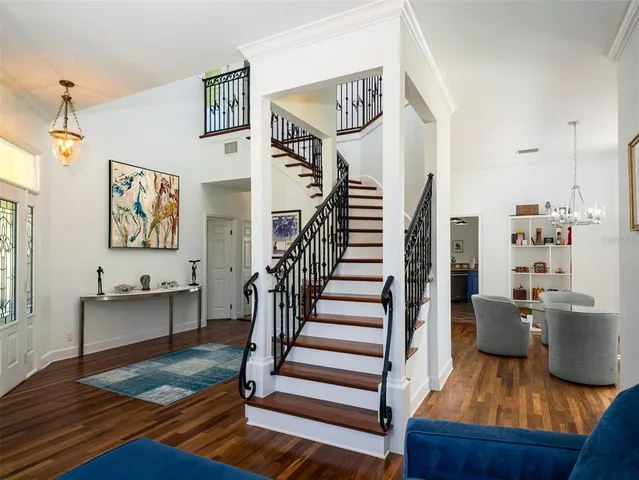 a living room with stainless steel appliances kitchen island granite countertop a stove a sink a dining table and chairs