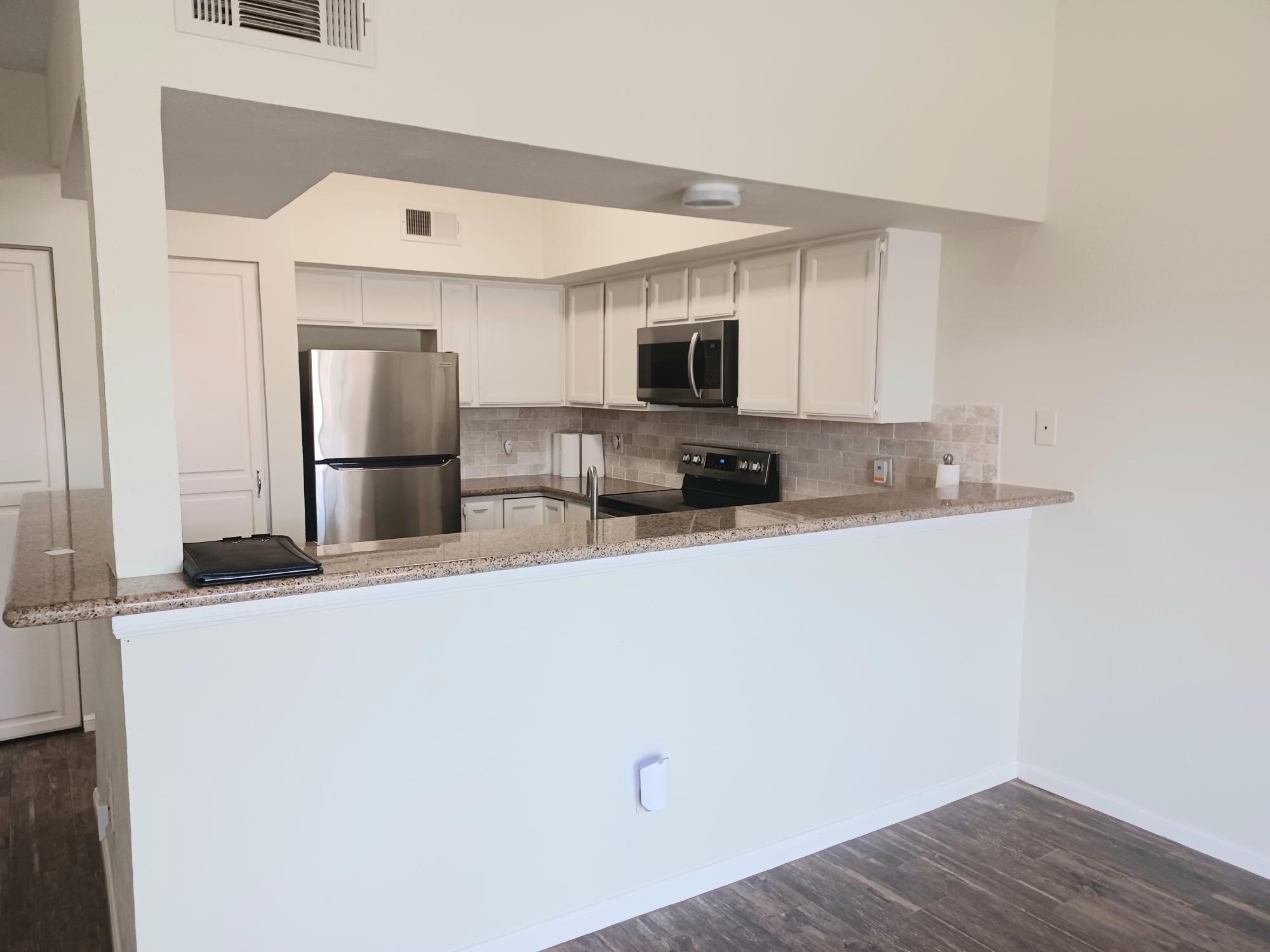 128 April Point Drive South Conroe, TX 77356 - Photo 12 of 26 a kitchen with stainless steel appliances a refrigerator sink and microwave