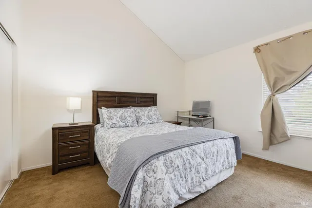 a bedroom with a bed and a night stand