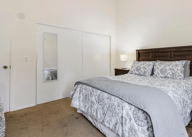 a bedroom with a bed and a night stand