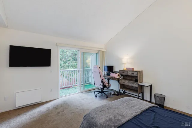 a view of a livingroom with workspace and a window