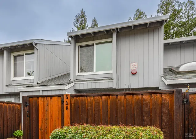 a front view of a house with a wooden fence
