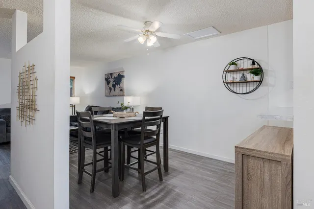 a view of a dining room with furniture and wooden floor
