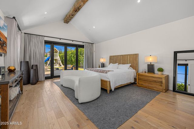 a bedroom with a large bed and a couch