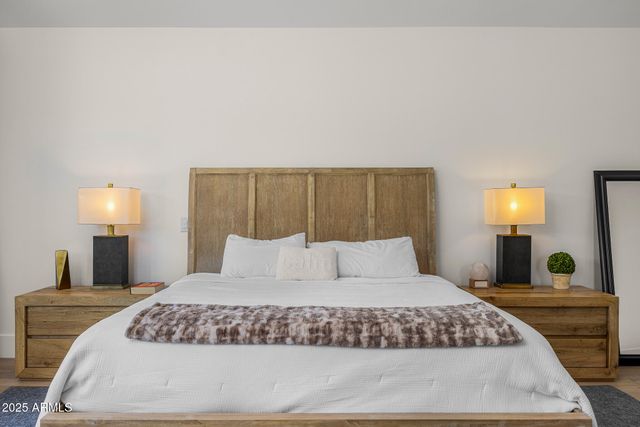 a spacious bedroom with a bed and a window