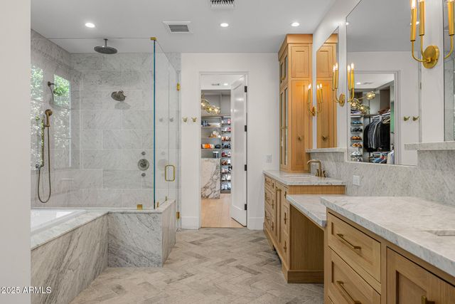 a bathroom with a sink and two mirror