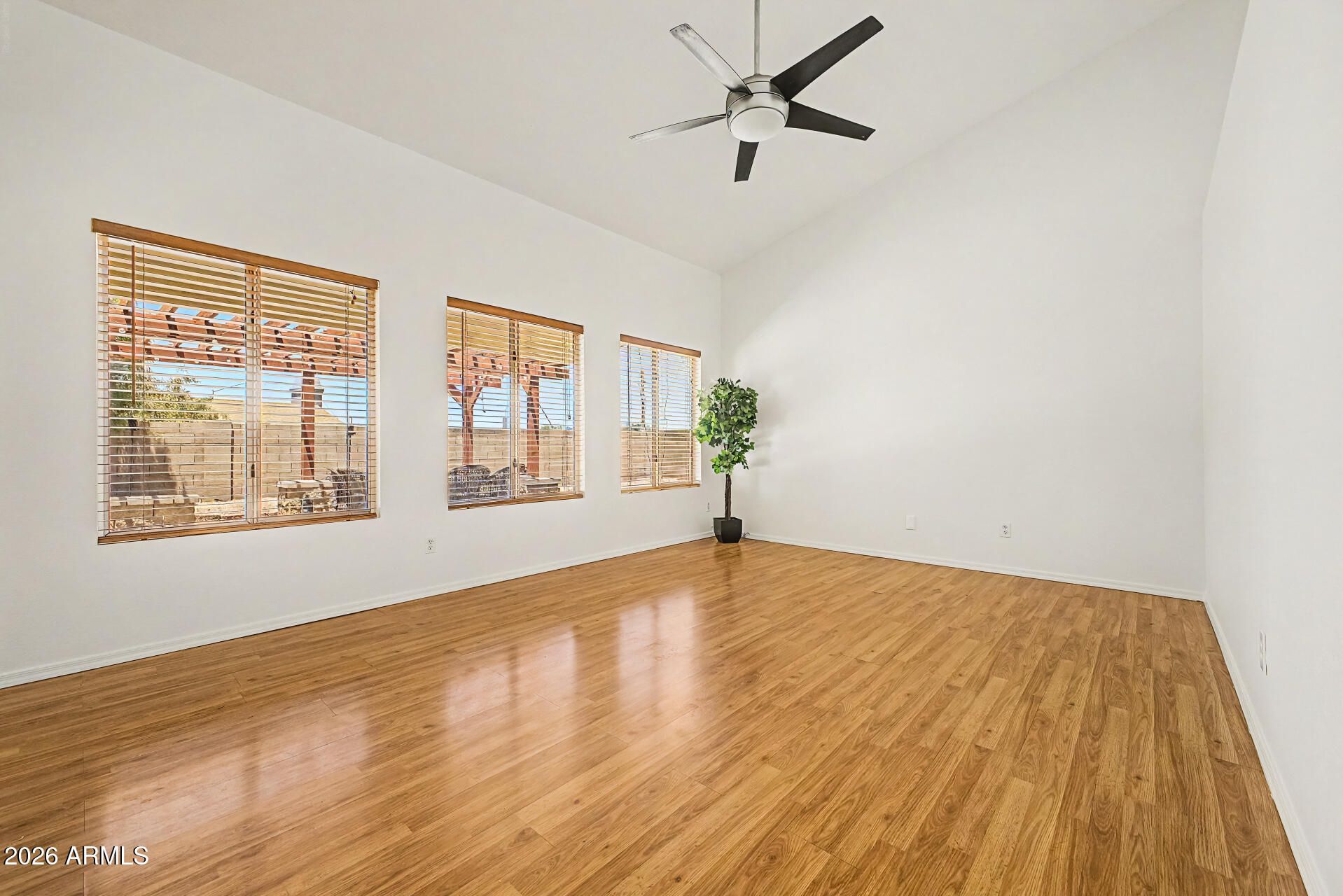 2762 North Ricardo Mesa, AZ 85215 - Photo 10 of 38 a view of an empty room with wooden floor and a window