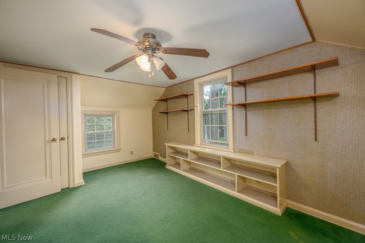 1422 Monument Road Northwest Canton, OH 44703 - Photo 15 of 31 Primary bedroom with multiple windows, ceiling fan and carpet floors