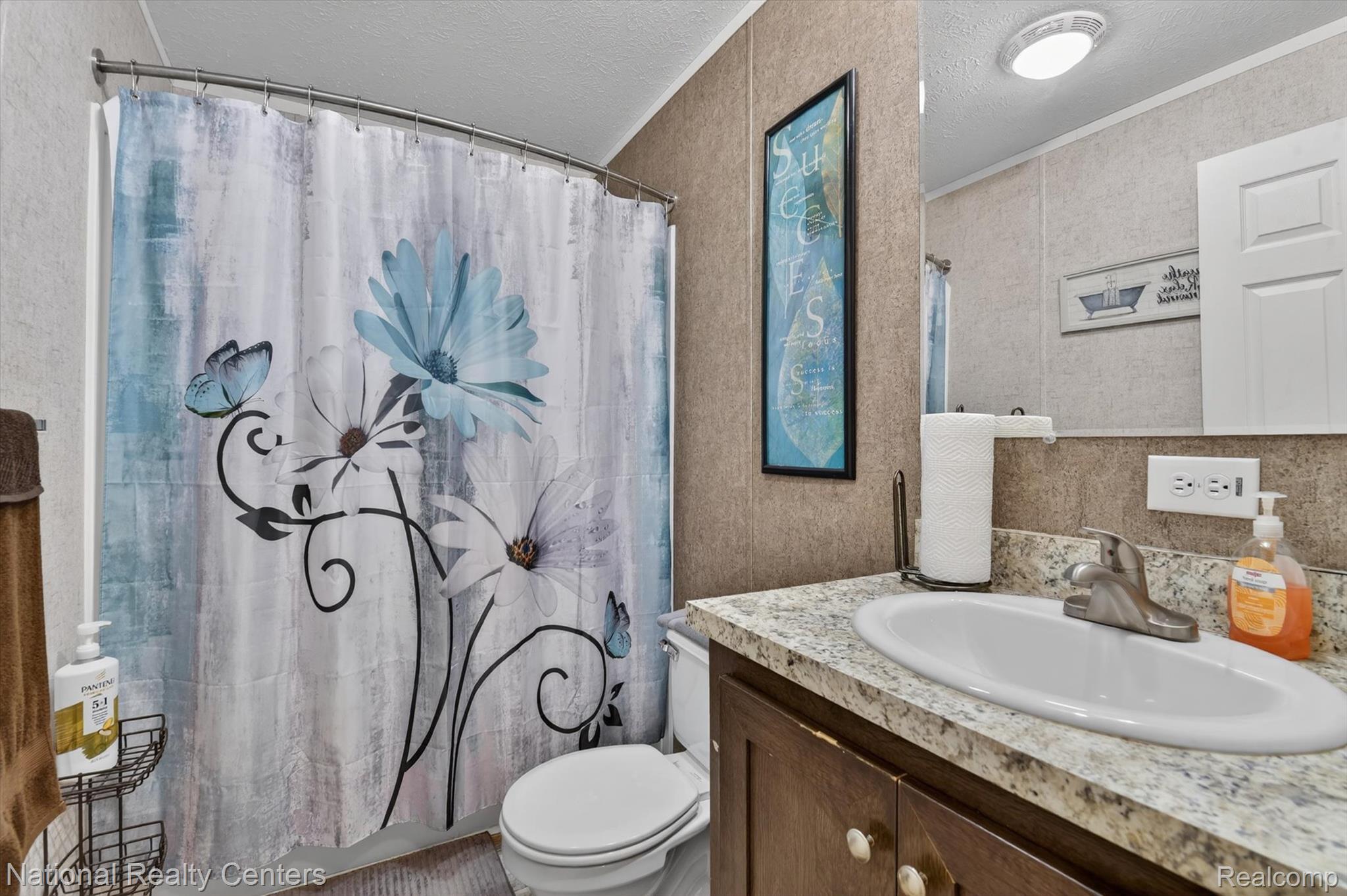 2735 South Wagner Road, Unit 103 Ann Arbor, MI 48103 - Photo 13 of 20 Full bath with a textured ceiling, vanity, shower / bath combination with curtain, and ornamental molding