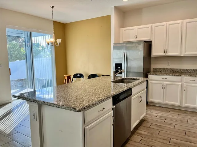 a bathroom with a granite countertop sink a mirror and a shower