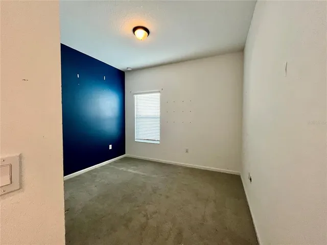 a view of a hallway with a dining room