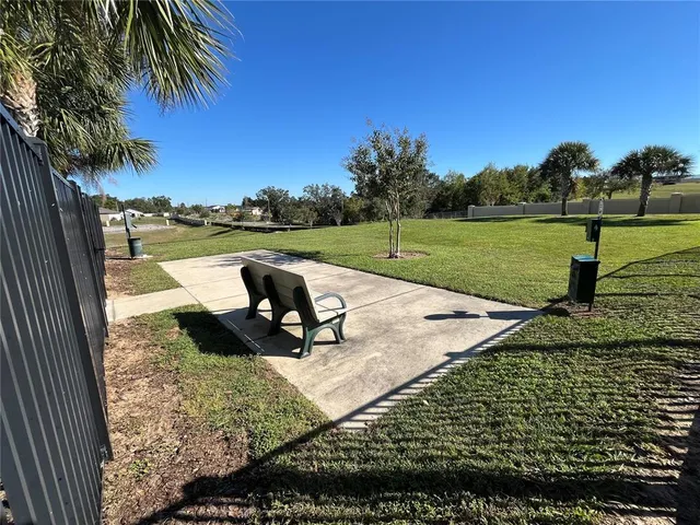 a view of a patio with a table and chairs under an umbrella
