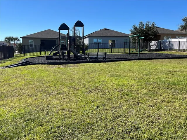 a view of a house with yard and sitting area