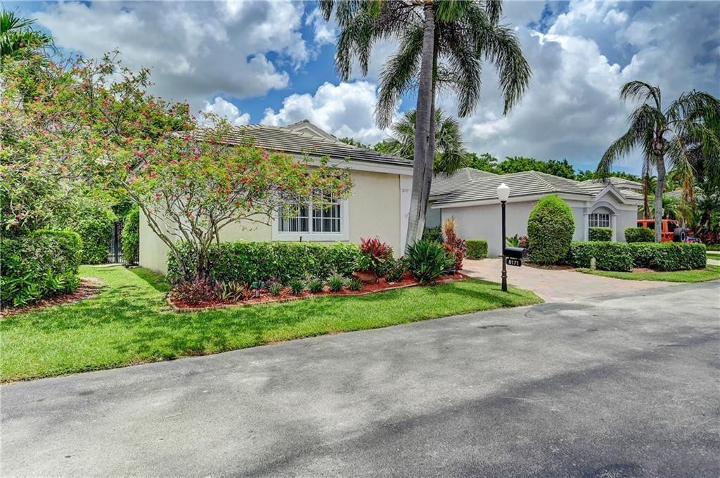 8171 Hampton Wood Drive Boca Raton, FL 33433 - Photo 3 of 56 a front view of house with yard and green space