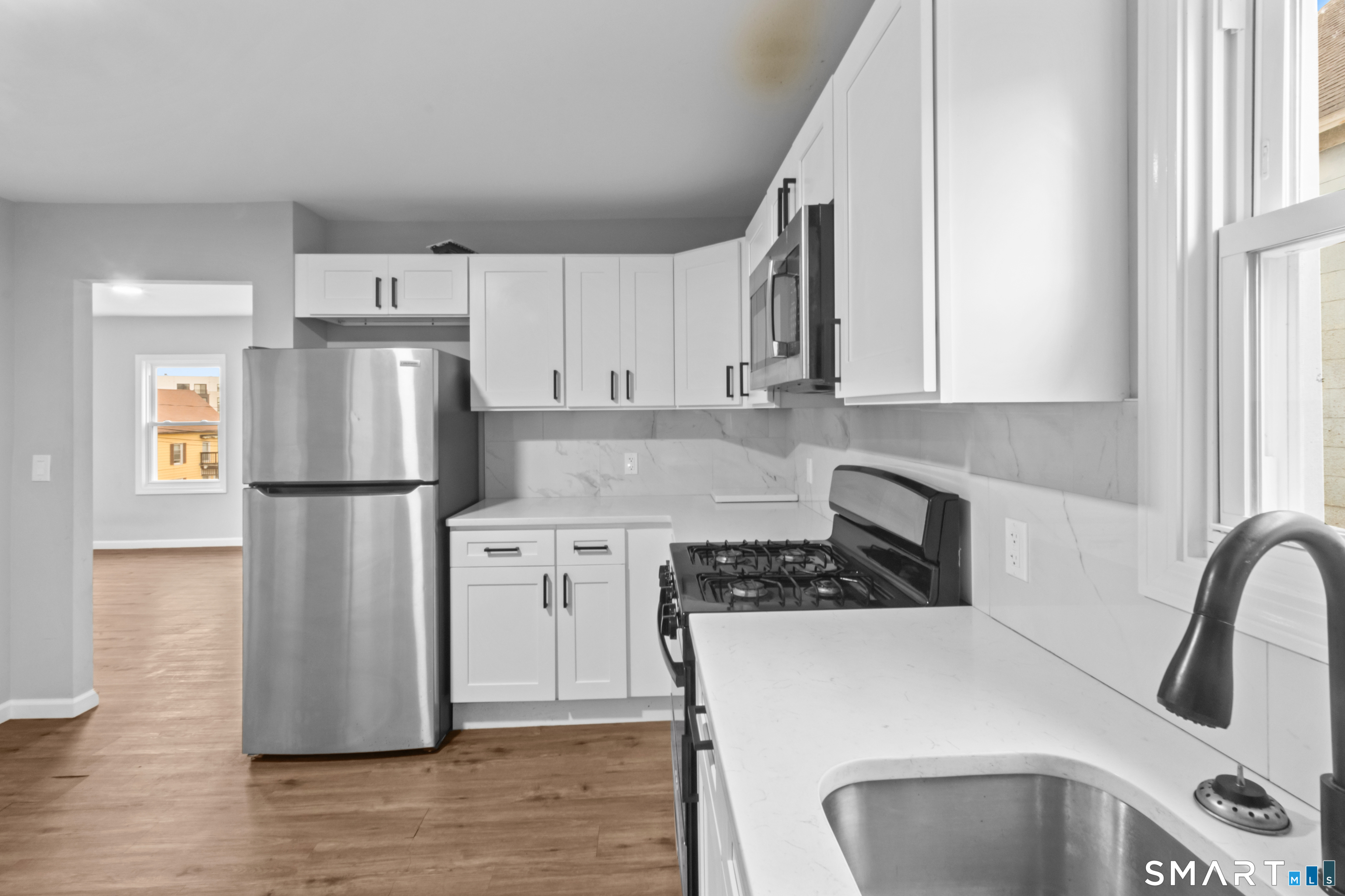 173 Shaw Street New London, CT 06320 - Photo 17 of 19 a kitchen with stainless steel appliances a refrigerator stove and sink