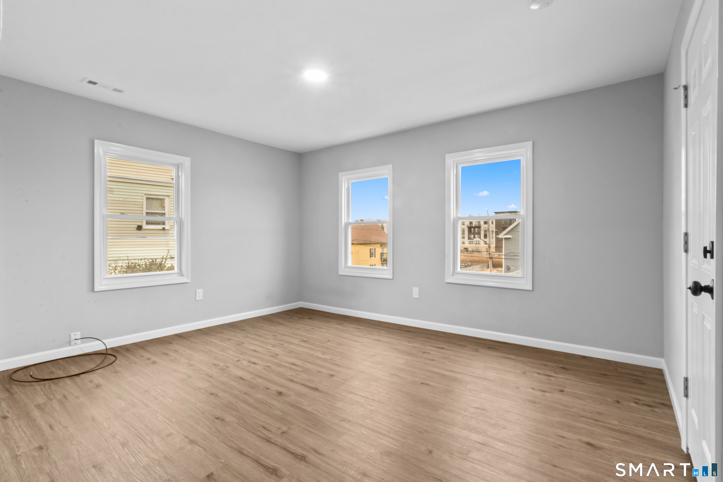 173 Shaw Street New London, CT 06320 - Photo 6 of 19 a view of an empty room with a window and wooden floor