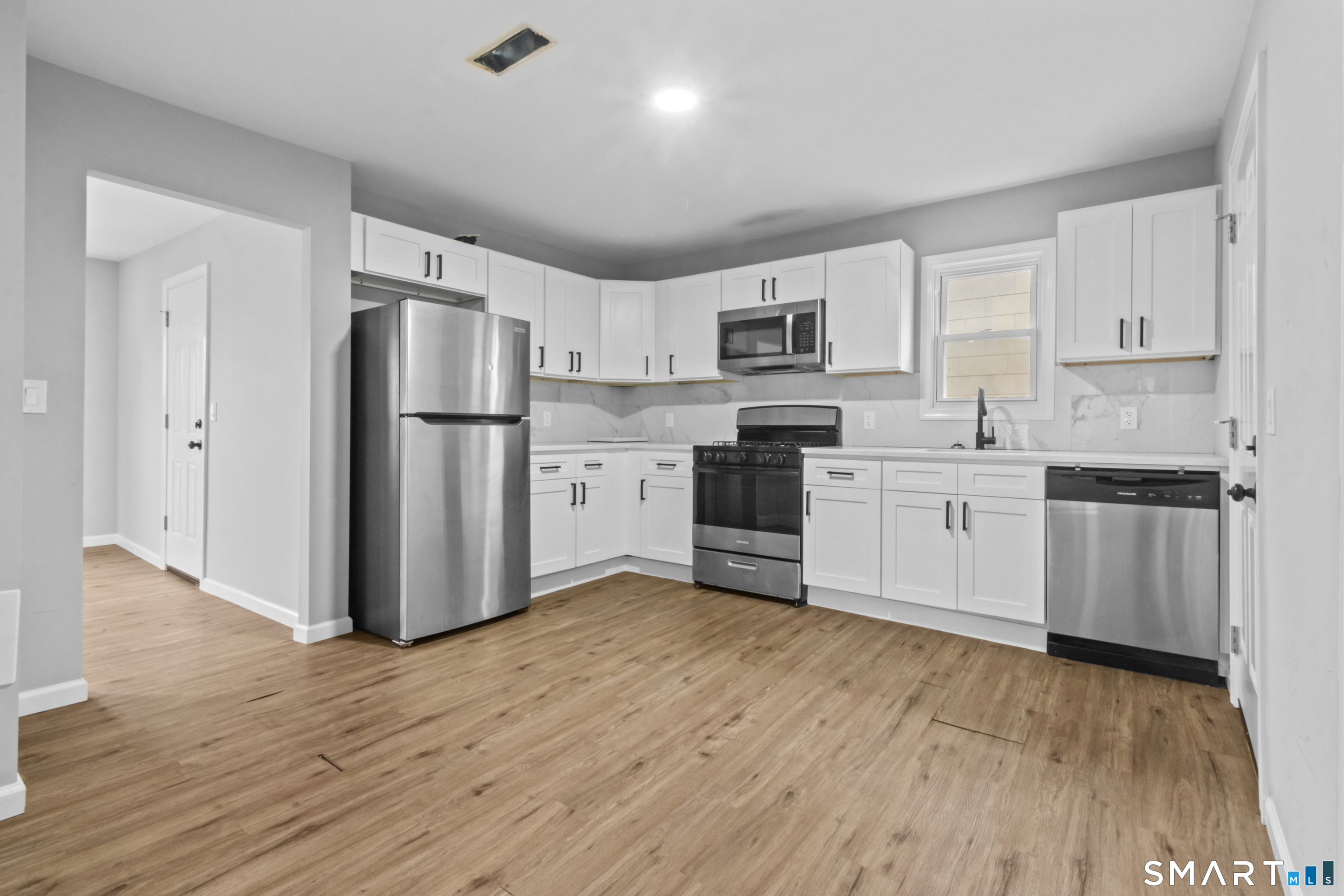 173 Shaw Street New London, CT 06320 - Photo 8 of 19 a kitchen with stainless steel appliances a refrigerator sink and cabinets