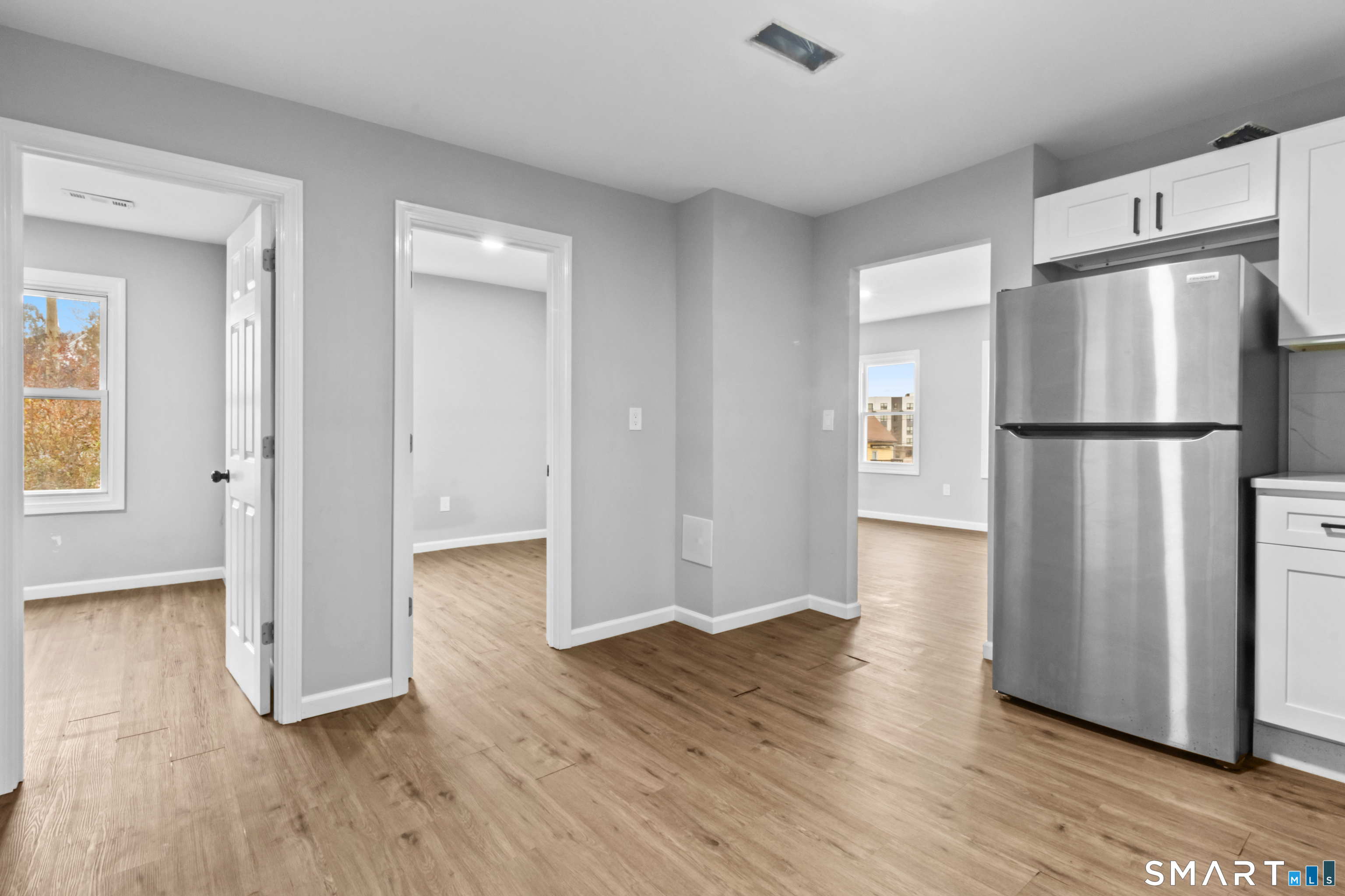 173 Shaw Street New London, CT 06320 - Photo 9 of 19 a view of a kitchen with wooden floor and a refrigerator