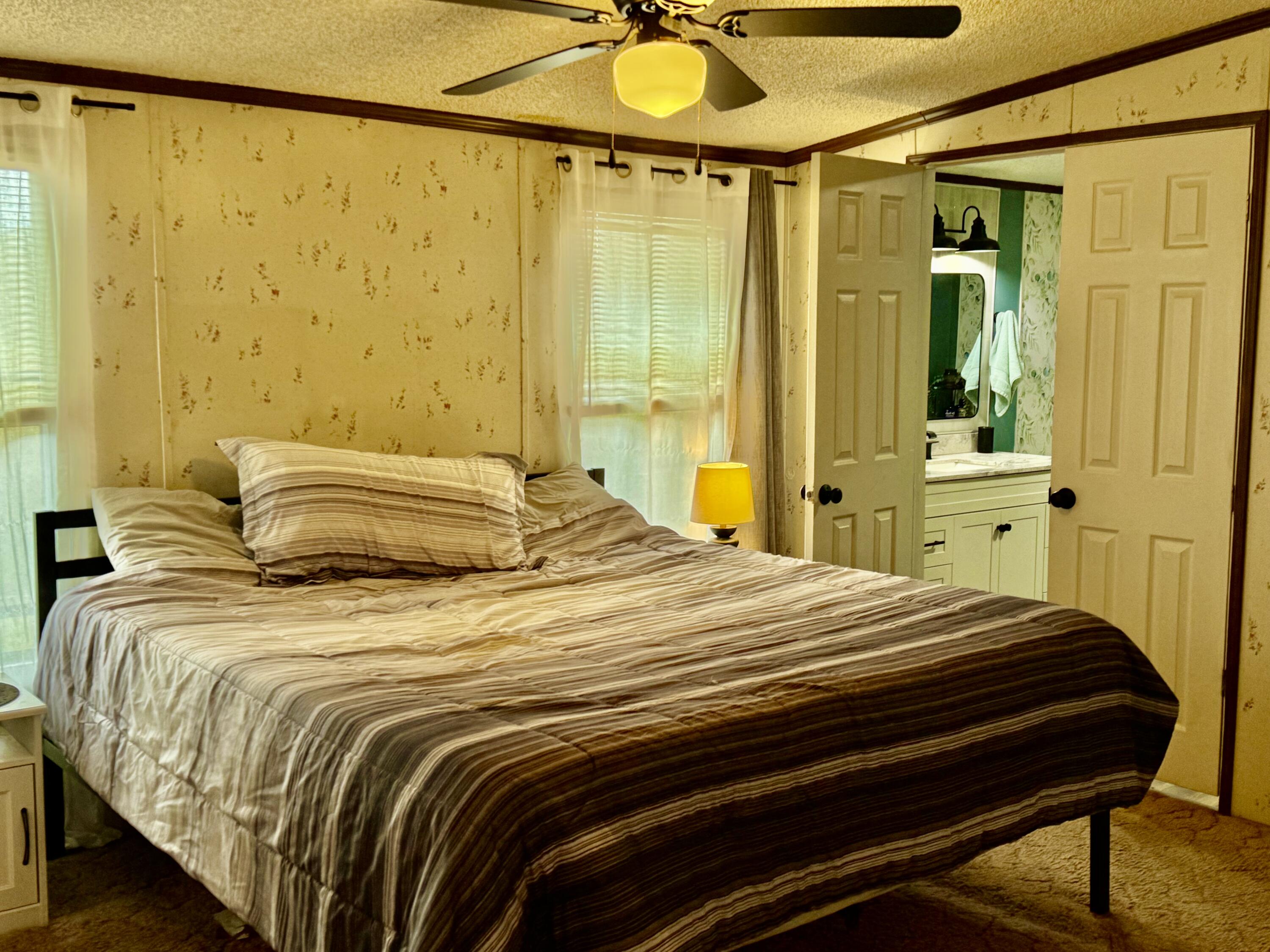 6249 Joppa Mill Road Moneta, VA 24121 - Photo 12 of 55 a bedroom with a bed and a chandelier