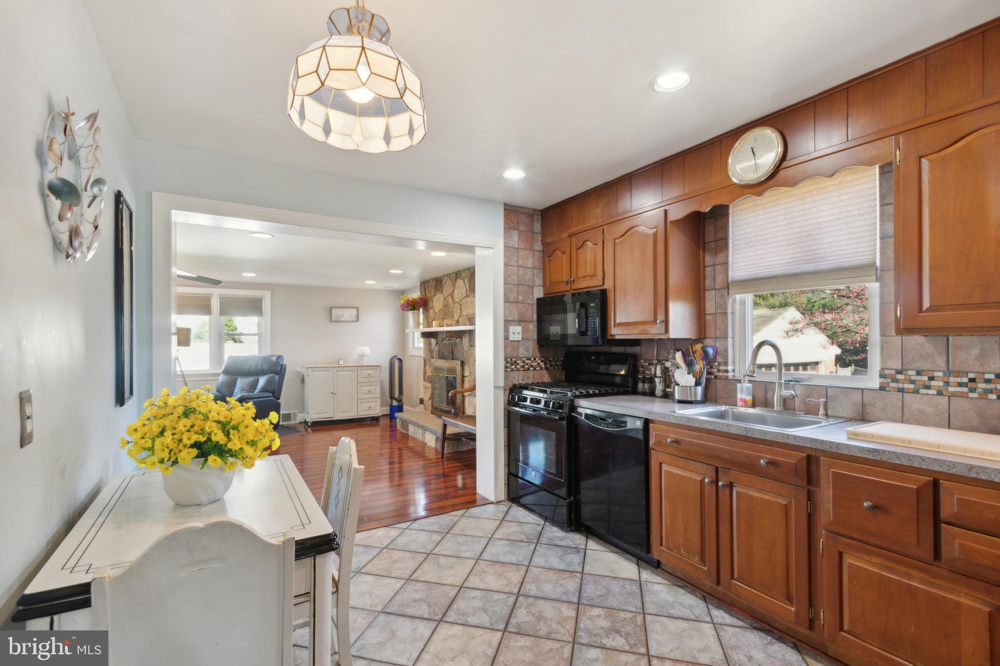 408 Barker Road Springfield, PA 19064 - Photo 12 of 22 a kitchen with stainless steel appliances granite countertop a sink a stove cabinets and a dining table