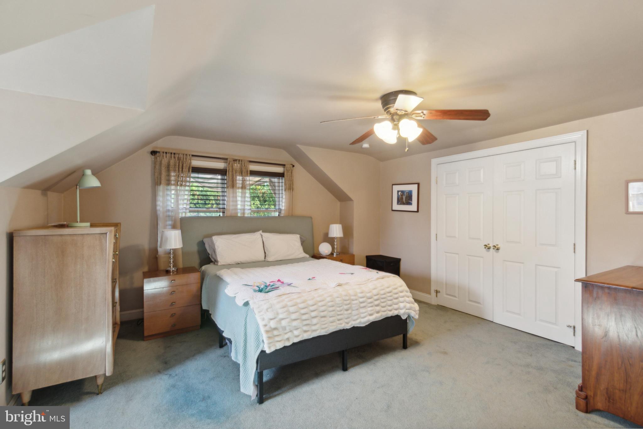 408 Barker Road Springfield, PA 19064 - Photo 17 of 22 a bedroom with a bed and a chandelier
