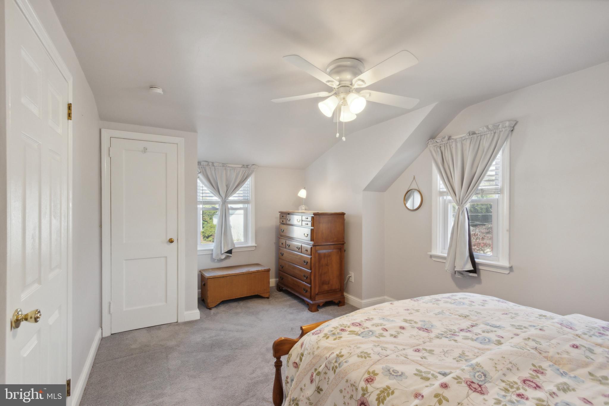 408 Barker Road Springfield, PA 19064 - Photo 19 of 22 a spacious bedroom with a bed and a chandelier