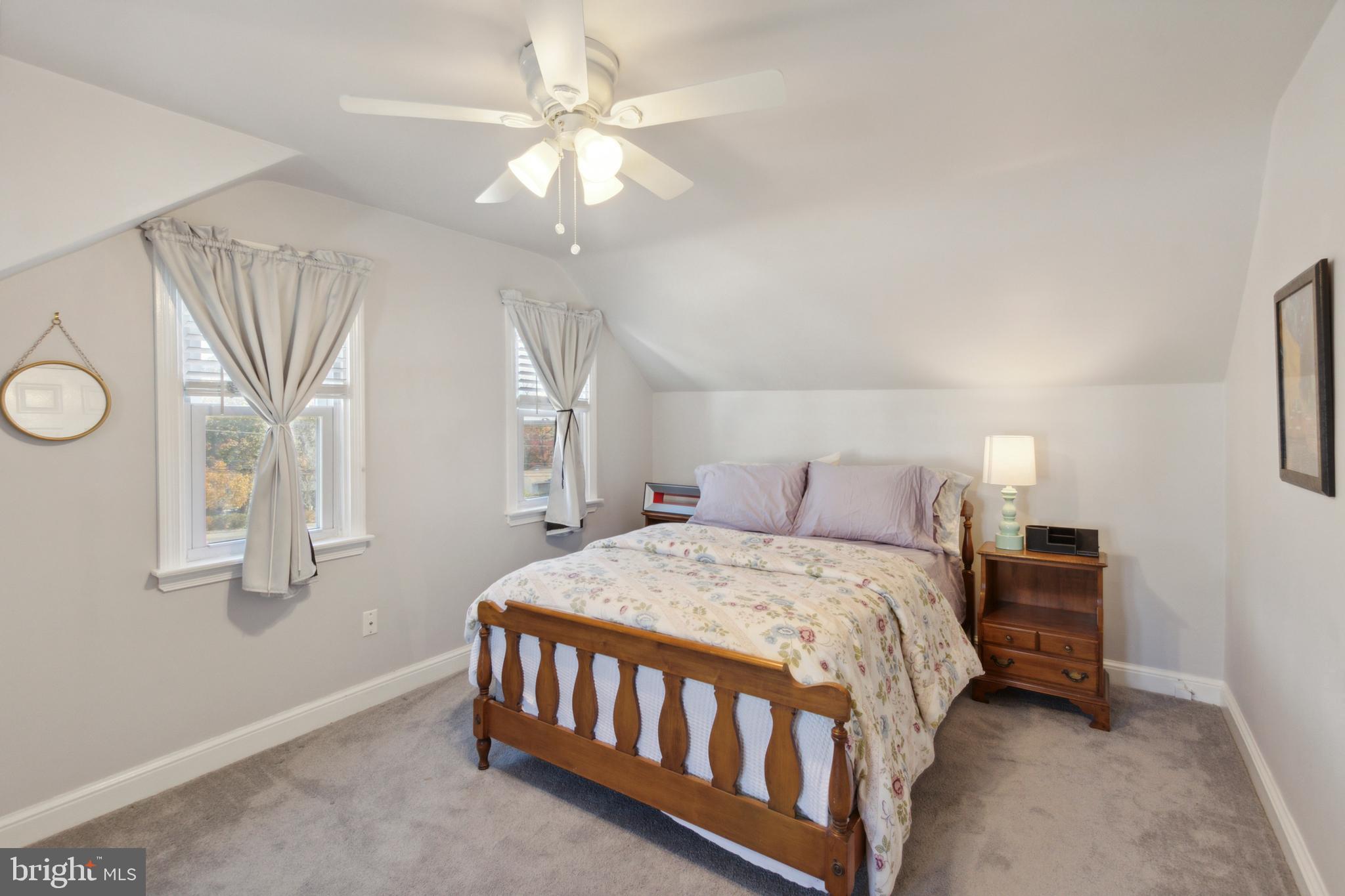 408 Barker Road Springfield, PA 19064 - Photo 20 of 22 a bedroom with a bed a chandelier and a window