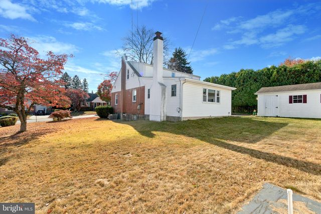 a view of a white house with a yard