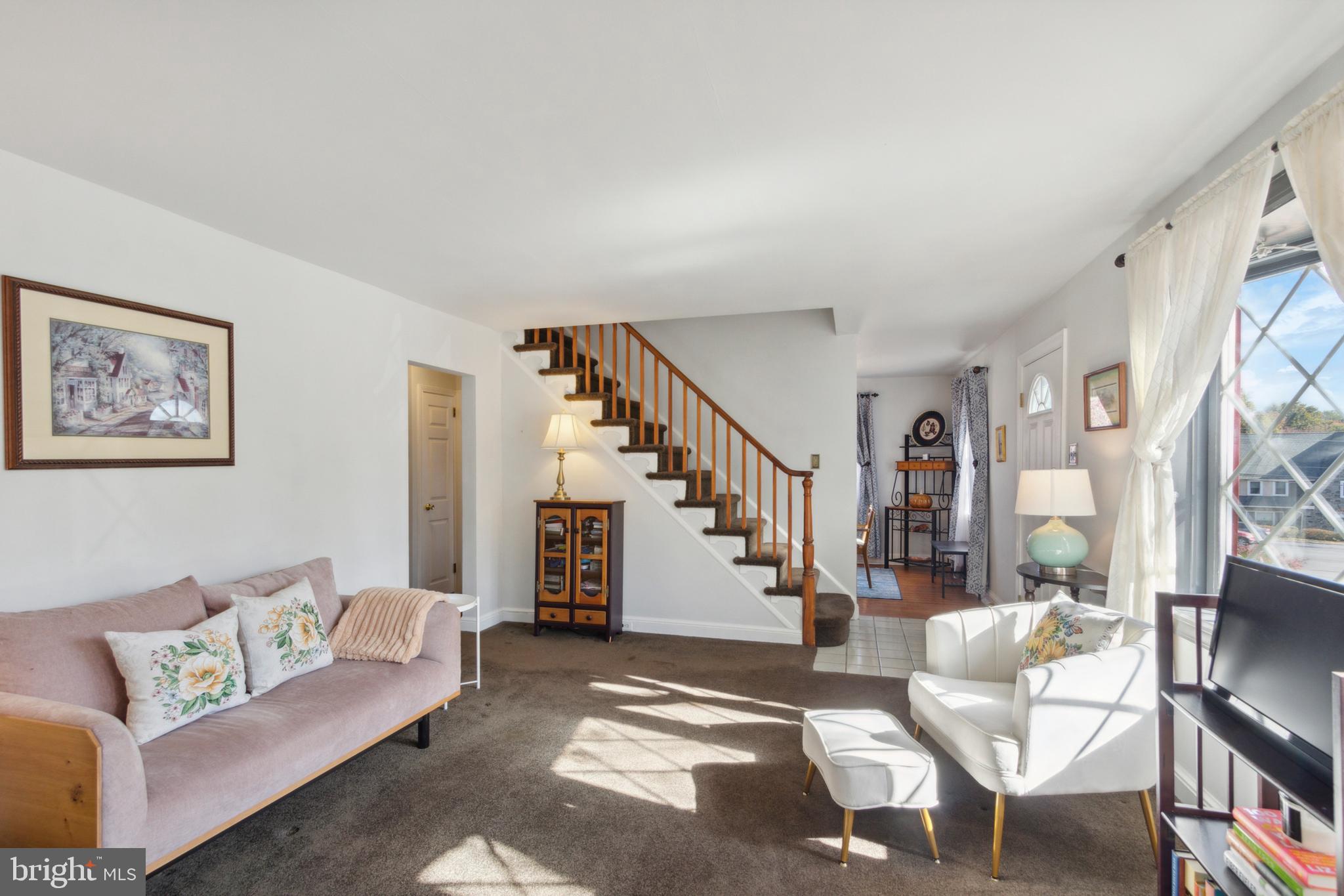408 Barker Road Springfield, PA 19064 - Photo 4 of 22 a living room with furniture and a painting