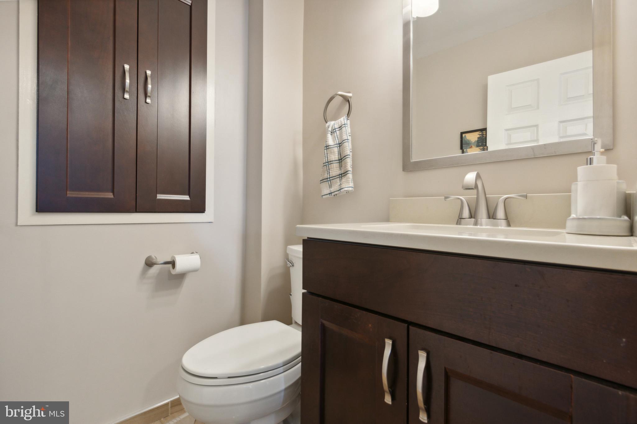 408 Barker Road Springfield, PA 19064 - Photo 8 of 22 a bathroom with a sink a toilet and mirror