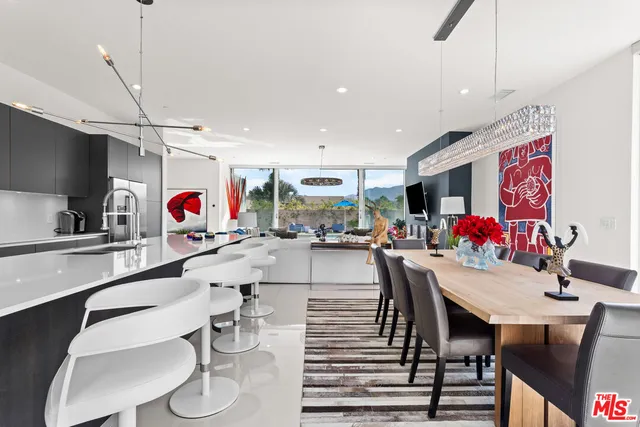 a kitchen with a dining table and chairs